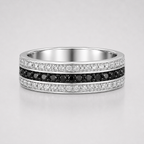 Silver ring with black and white gemstones on a light gray background