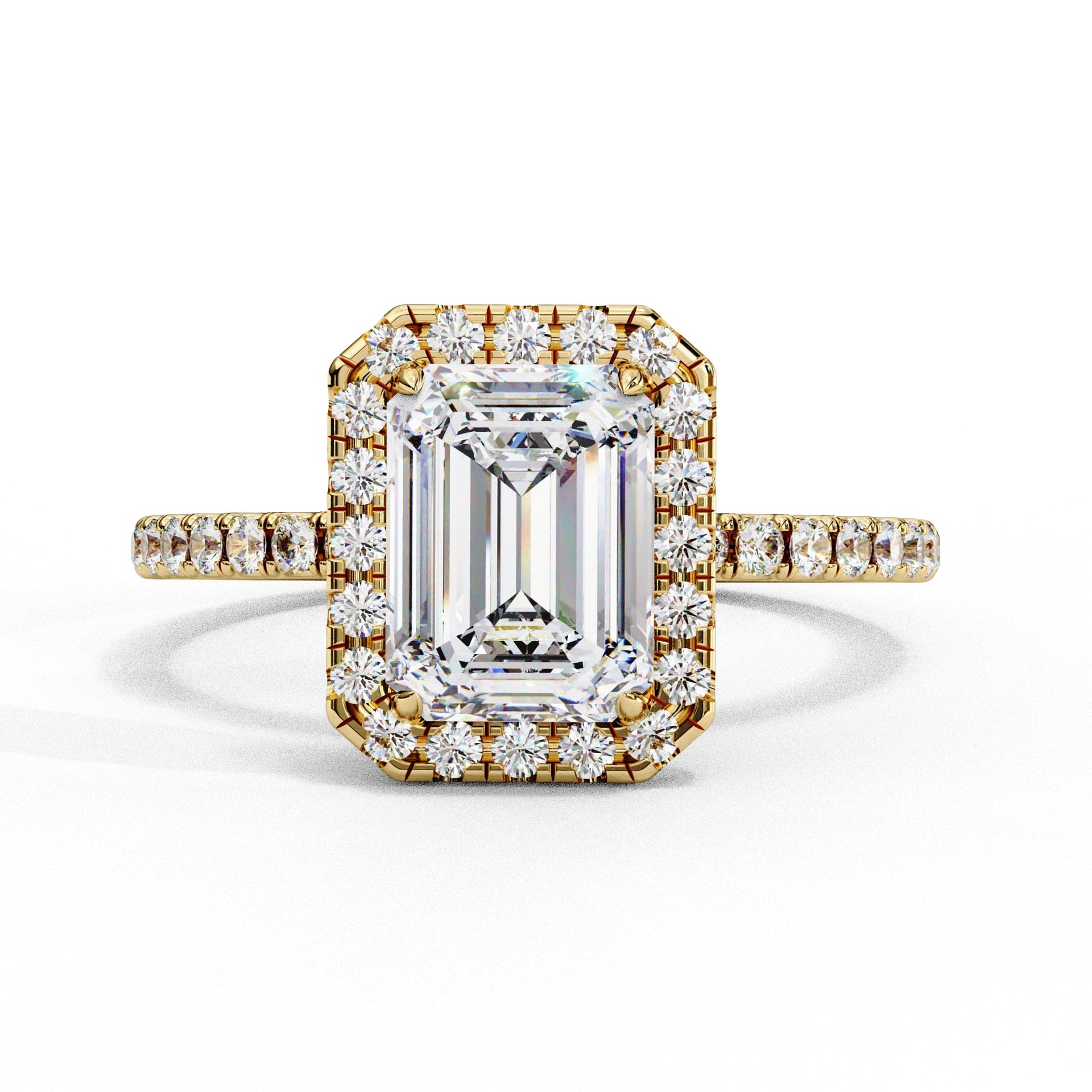 Gold ring with emerald-cut diamond and smaller diamonds on a white background