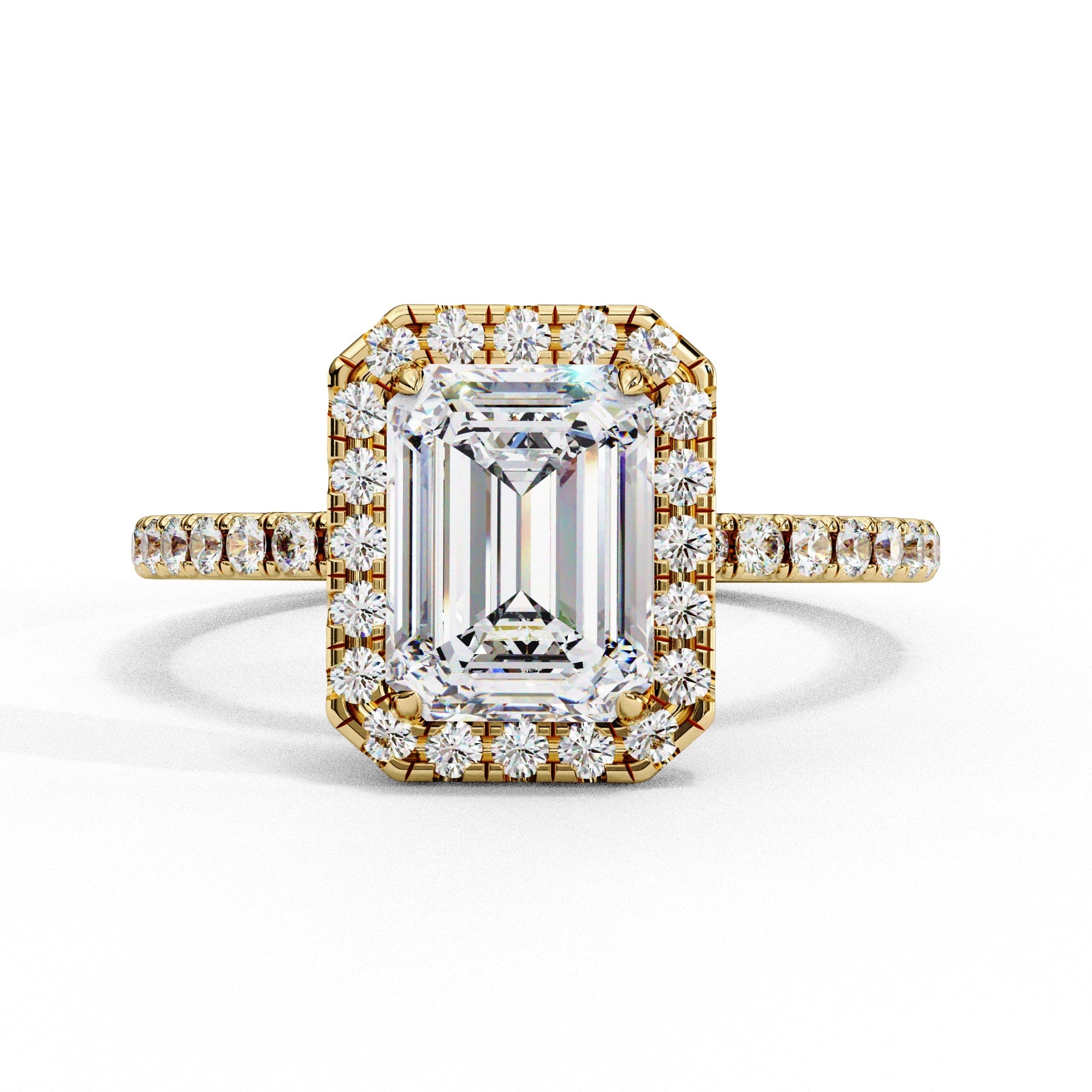 Gold ring with emerald-cut diamond and smaller diamonds on a white background