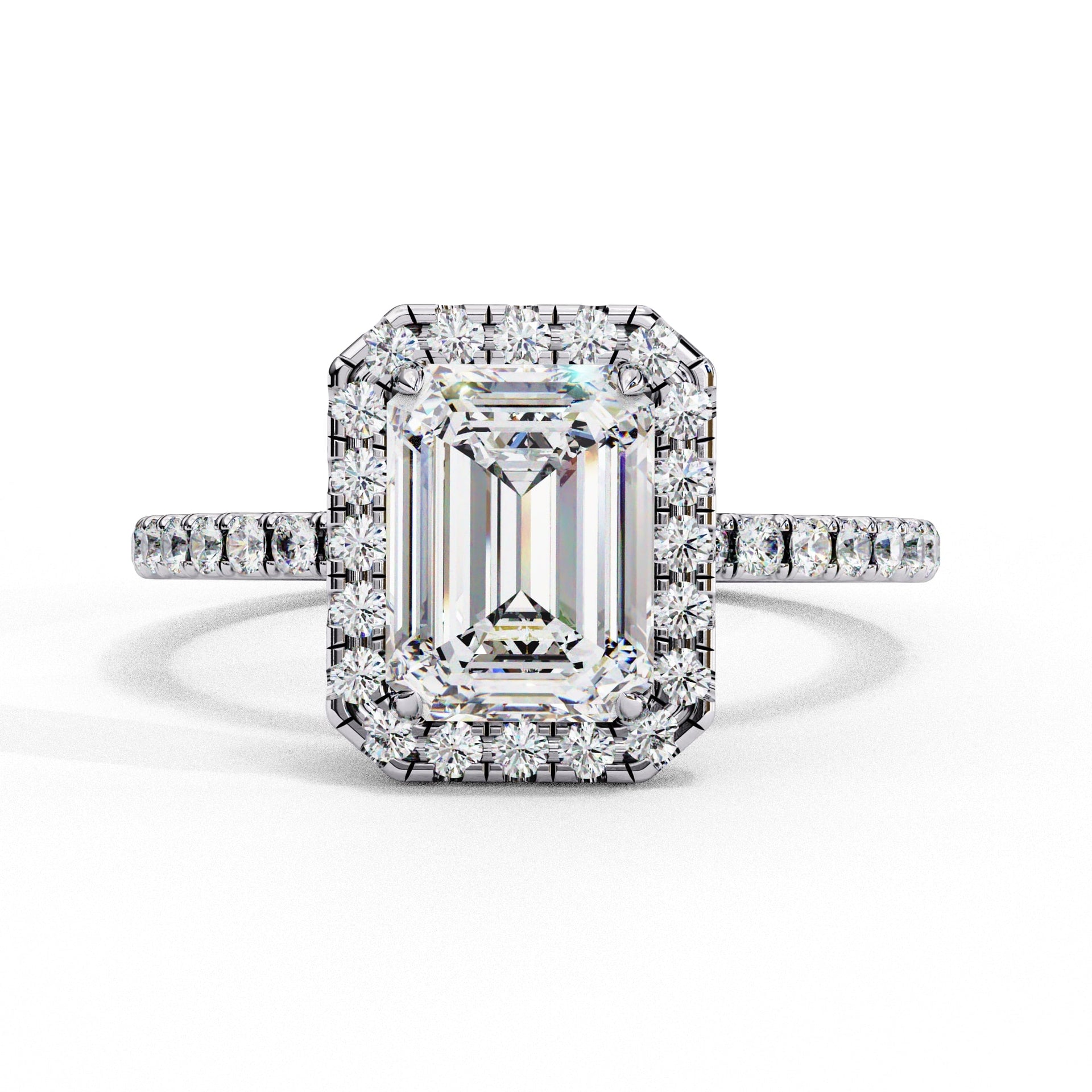 Diamond ring with emerald-cut center stone and halo on a white background