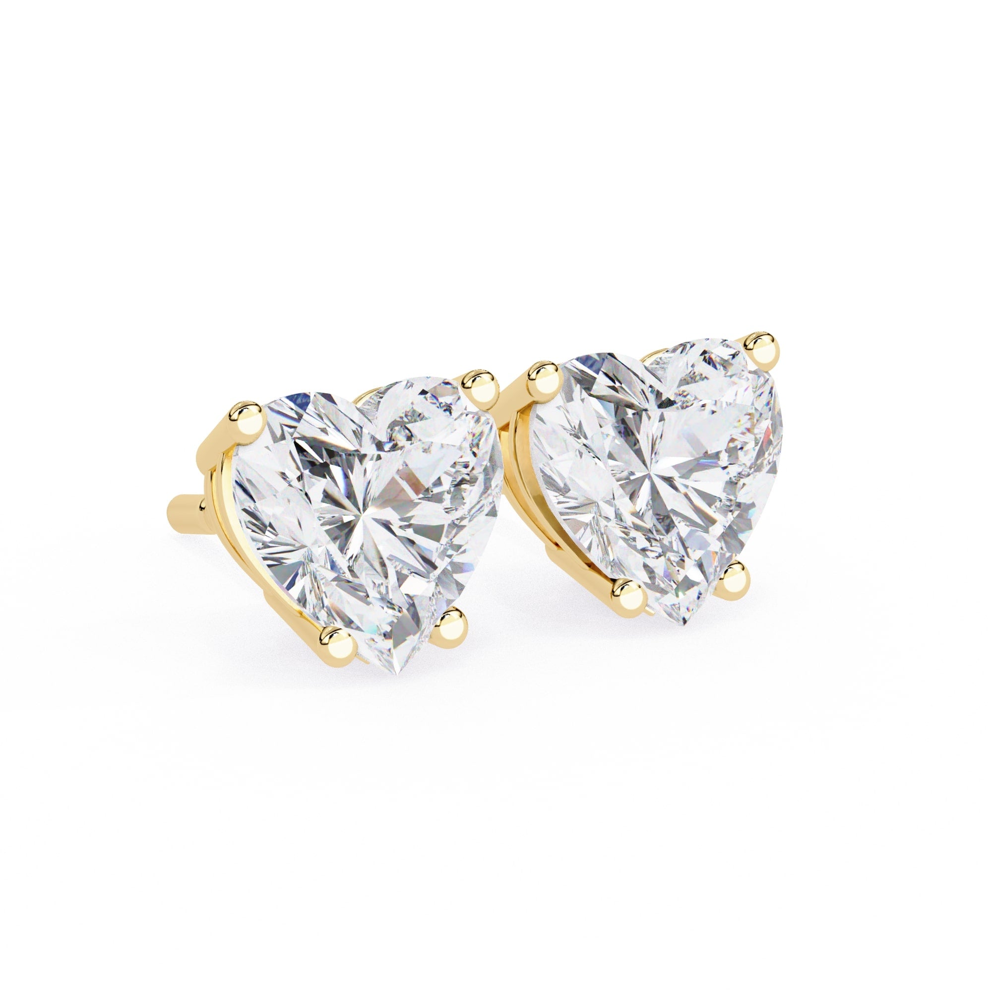 Heart-shaped diamond earrings with gold prongs on a white background