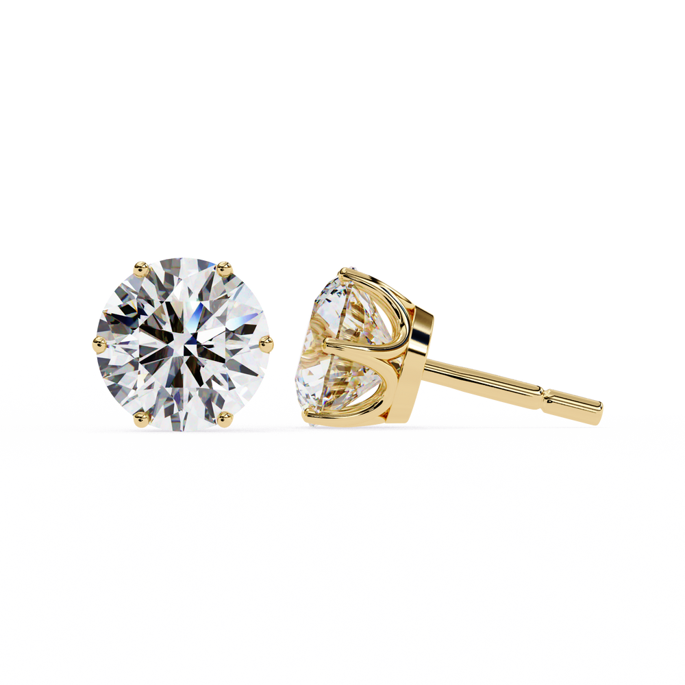 Gold stud earrings with clear gemstones on a white background