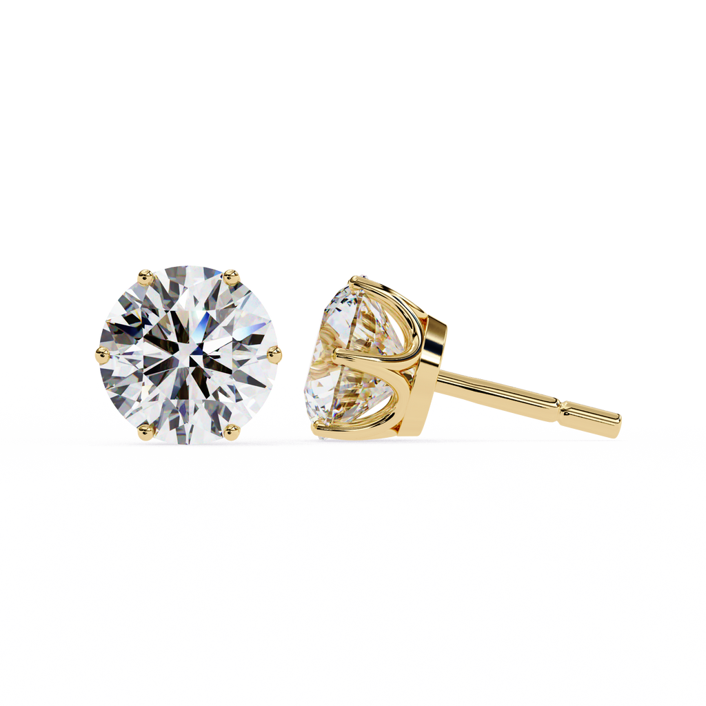 Gold stud earrings with clear gemstones on a white background
