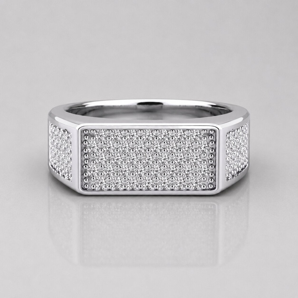 Silver ring with diamond accents on a light gray background