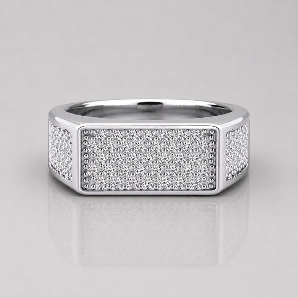 Silver ring with diamond accents on a light gray background