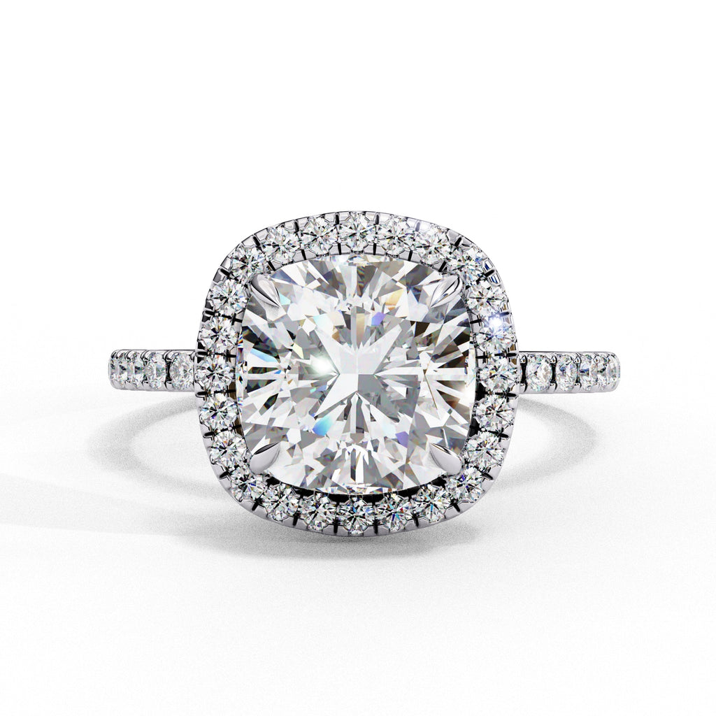 Diamond ring with a large central gemstone and smaller stones around on a white background