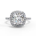 Diamond ring with a large central gemstone and smaller stones around on a white background