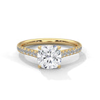 Gold ring with a large diamond and smaller diamonds on the band against a white background