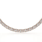 Diamond necklace with rose gold setting on a white background