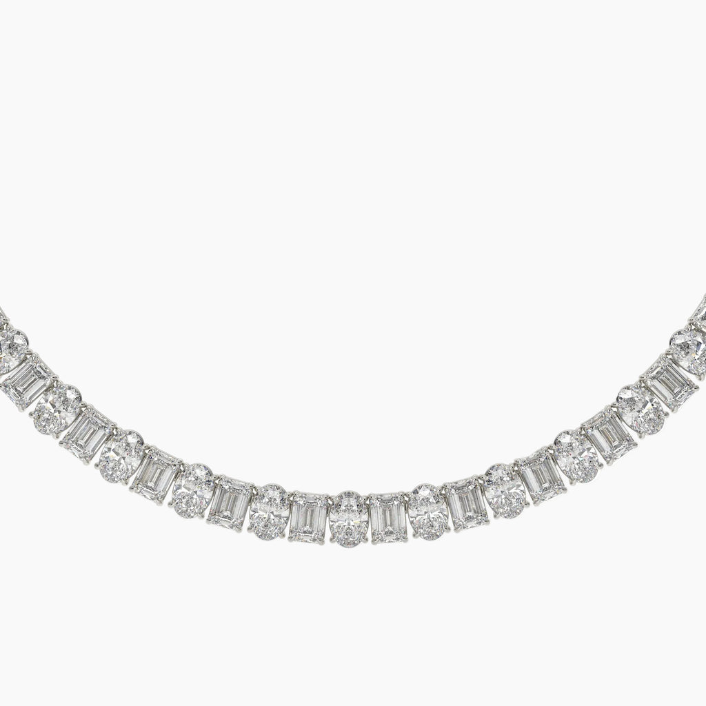 Diamond necklace with baguette and round cut diamonds on a white background