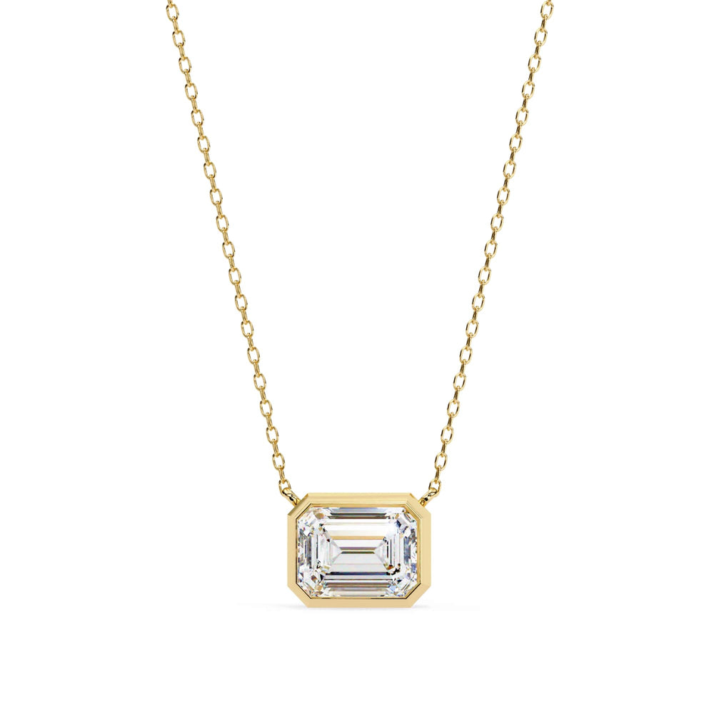 Silver pendant with a green gemstone on a white background