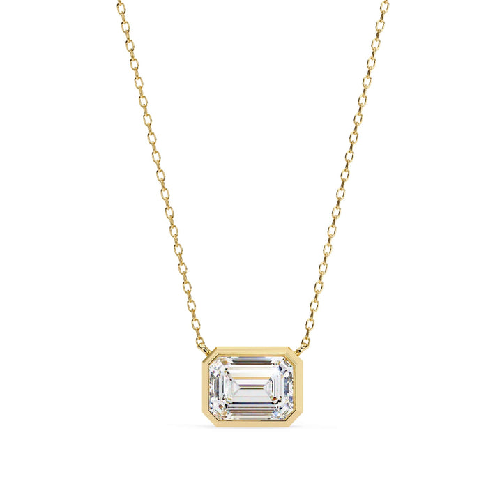 Silver pendant with a green gemstone on a white background