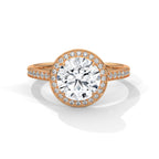 Rose gold ring with a large diamond and smaller diamonds on the band against a white background