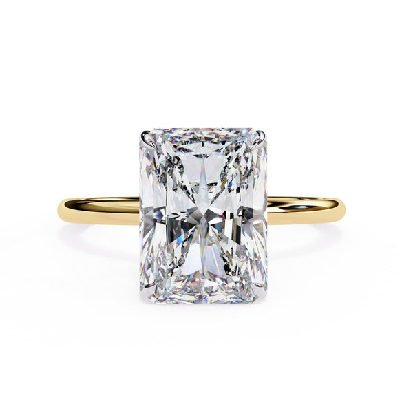 Gold ring with a large rectangular diamond on a white background