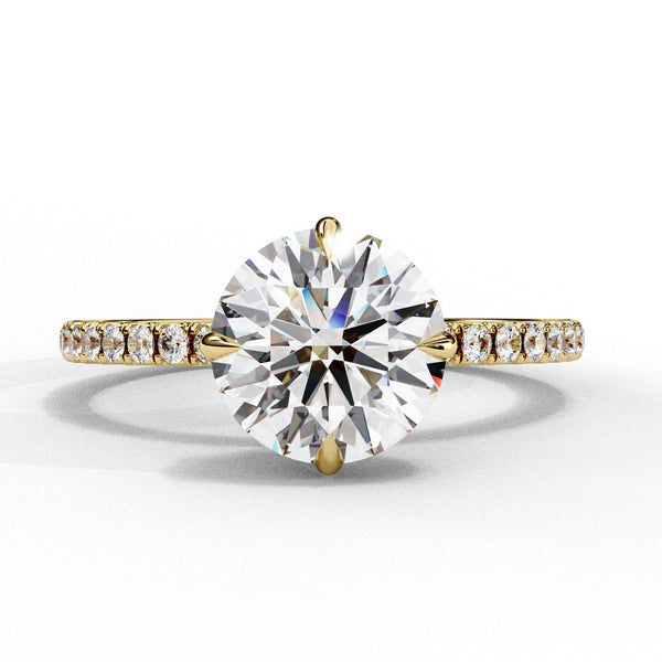 Gold ring with a large diamond and smaller diamonds on the band against a white background