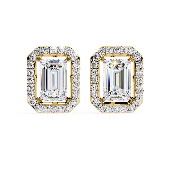 Pair of diamond earrings with gold frames on a white background