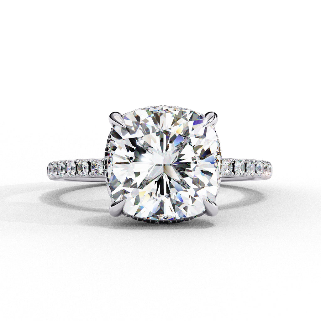Diamond ring with a large central gemstone and smaller stones on a white background