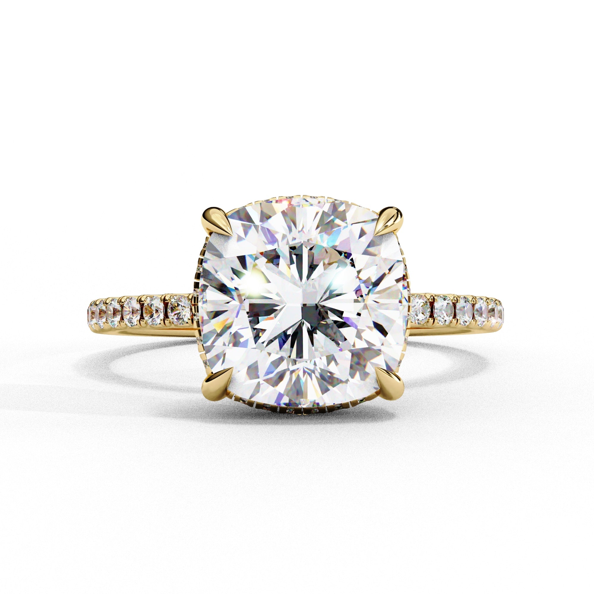 Gold ring with a large diamond and smaller diamonds on the band against a white background