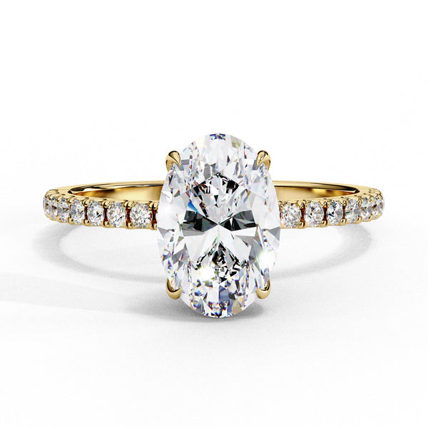Gold ring with a large diamond and smaller diamonds on the band against a white background