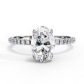 Diamond ring with a pear-shaped center stone on a white background