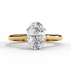 Gold ring with two large diamonds on a white background