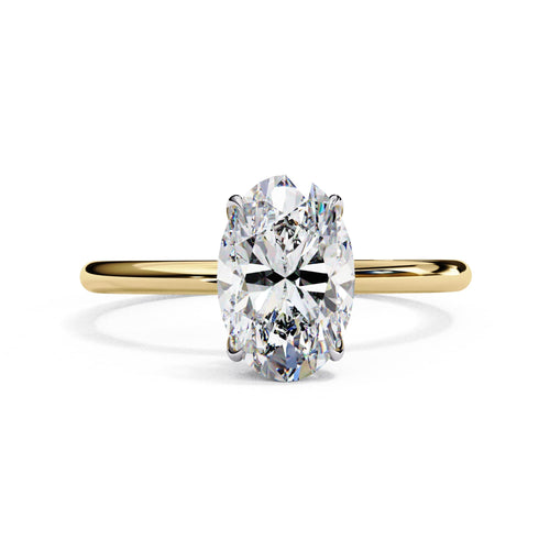 Gold ring with a large diamond on a white background