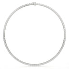 Silver necklace with small round stones on a white background
