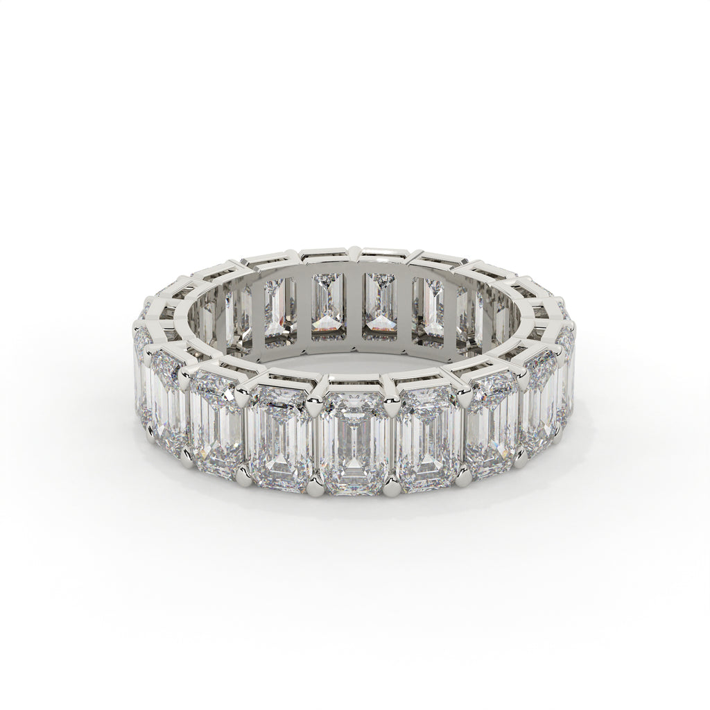 Diamond ring with emerald-cut stones on a white background