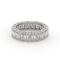 Diamond ring with emerald-cut stones on a white background
