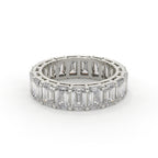 Diamond ring with emerald-cut stones on a white background