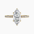 Gold ring with a large marquise-shaped diamond and smaller diamonds on the band against a white background