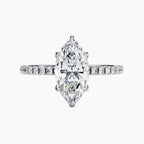 Diamond ring with a pear-shaped center stone on a white background