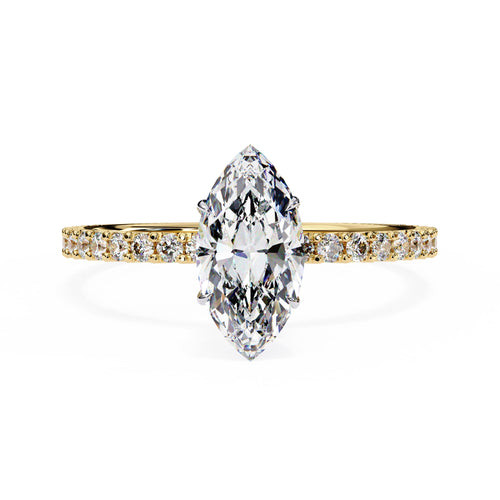 Diamond ring with a pear-shaped center stone on a white background