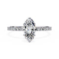 Diamond ring with a pear-shaped center stone on a white background