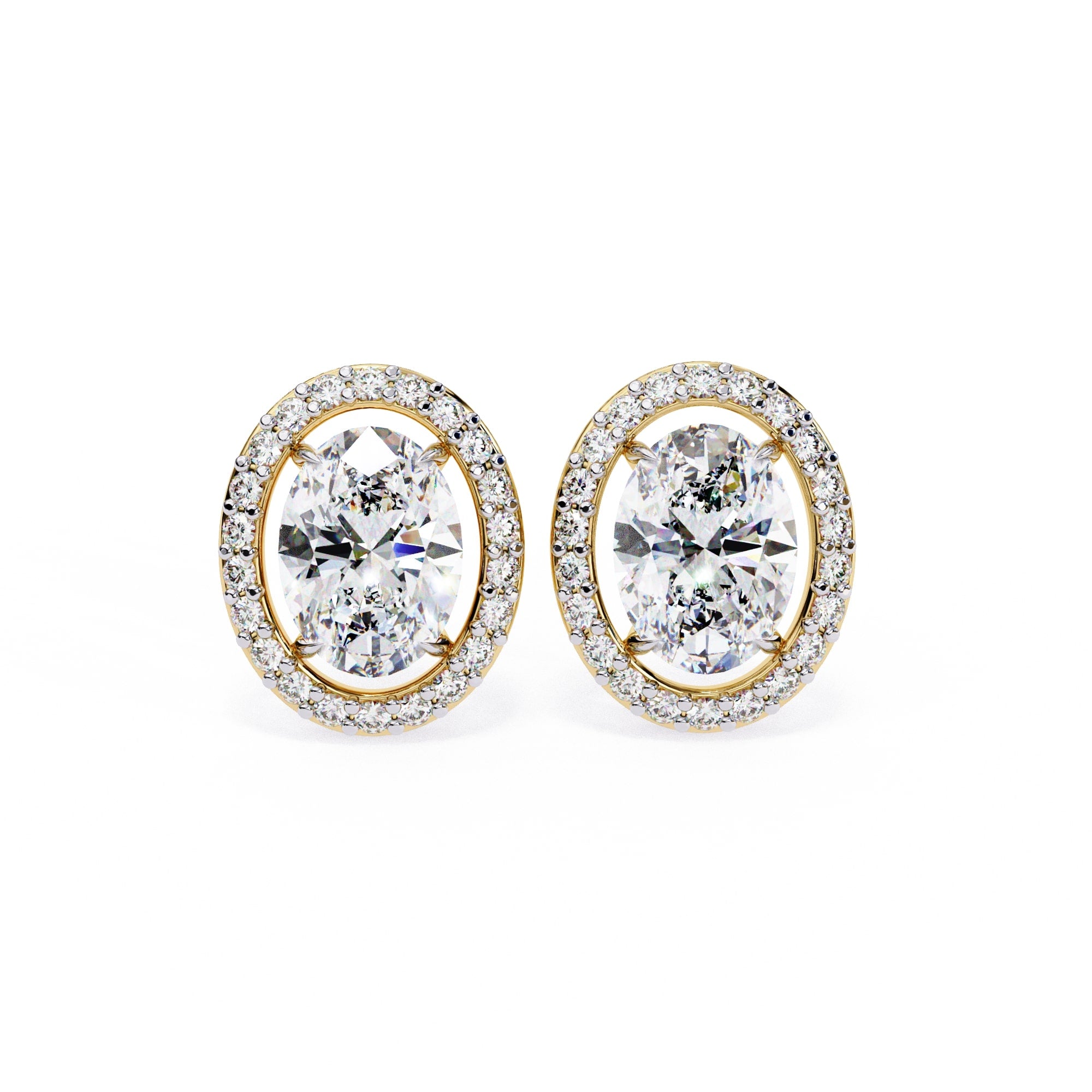 Pair of diamond earrings with gold rims on a white background
