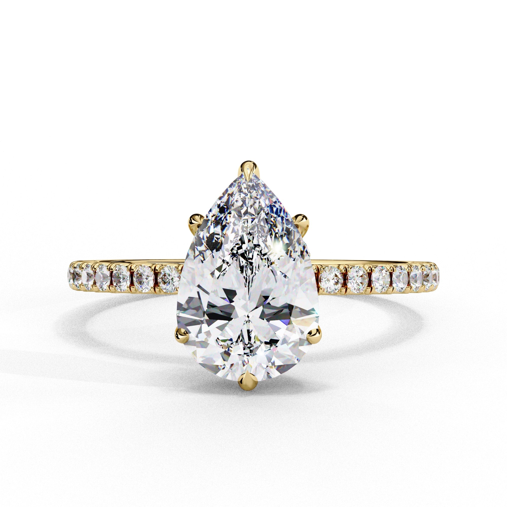 Gold ring with a pear-shaped diamond and smaller diamonds on the band against a white background