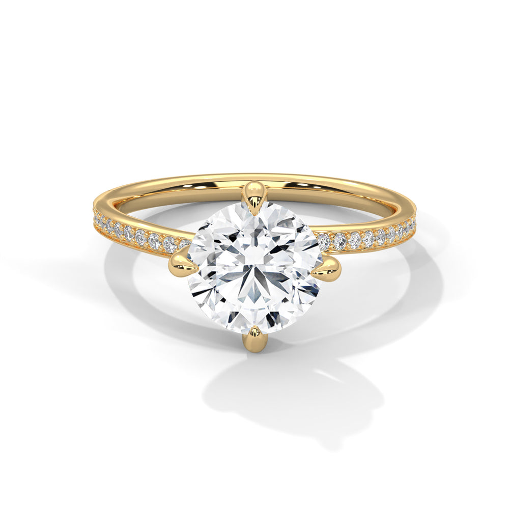 Gold ring with a large diamond and smaller diamonds on the band against a white background