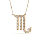 Gold necklace with a zodiac sign pendant on a white background