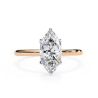 Rose gold ring with a marquise-shaped diamond on a white background