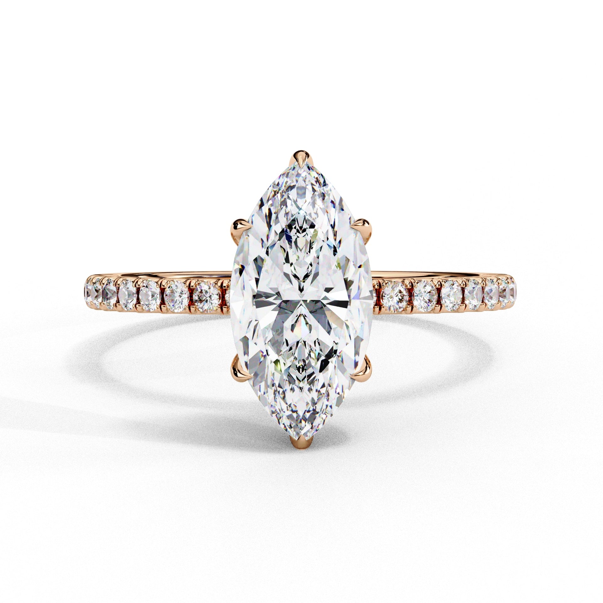Diamond ring with a pear-shaped center stone on a white background