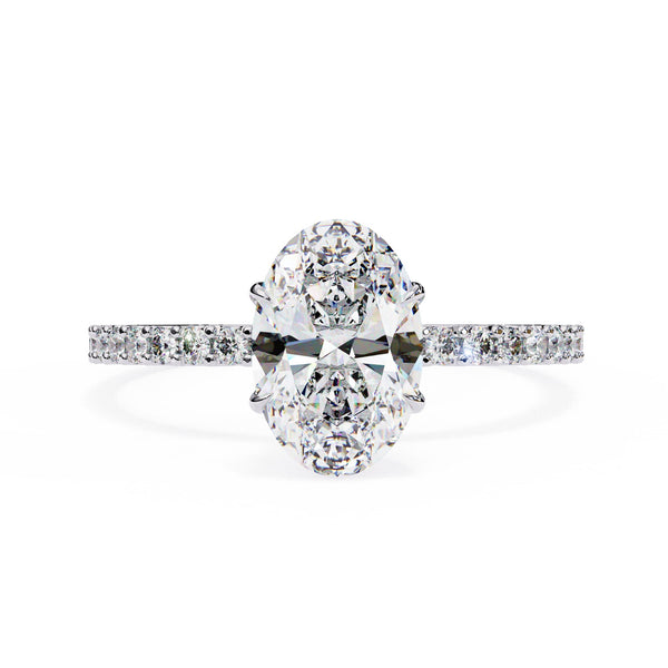 Diamond ring with two large oval diamonds and smaller diamonds on the band against a white background