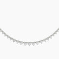 Delicate silver necklace with small diamonds on a white background