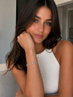 Woman wearing a bracelet with a neutral background