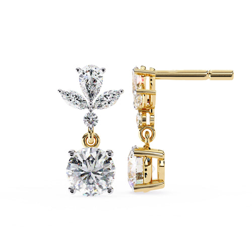 Gold earrings with clear gemstones on a white background