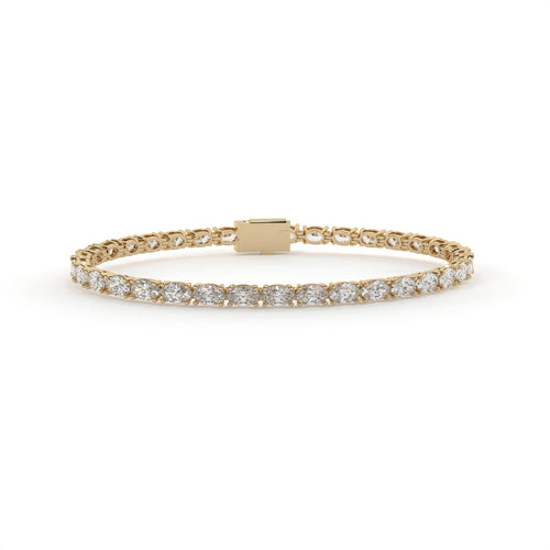 Gold bracelet with diamond accents on a white background
