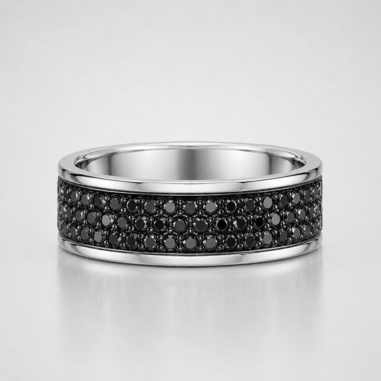 Multiple round cut black diamond men's eternity pavé ring featuring rows of black diamonds set in a polished white gold band.