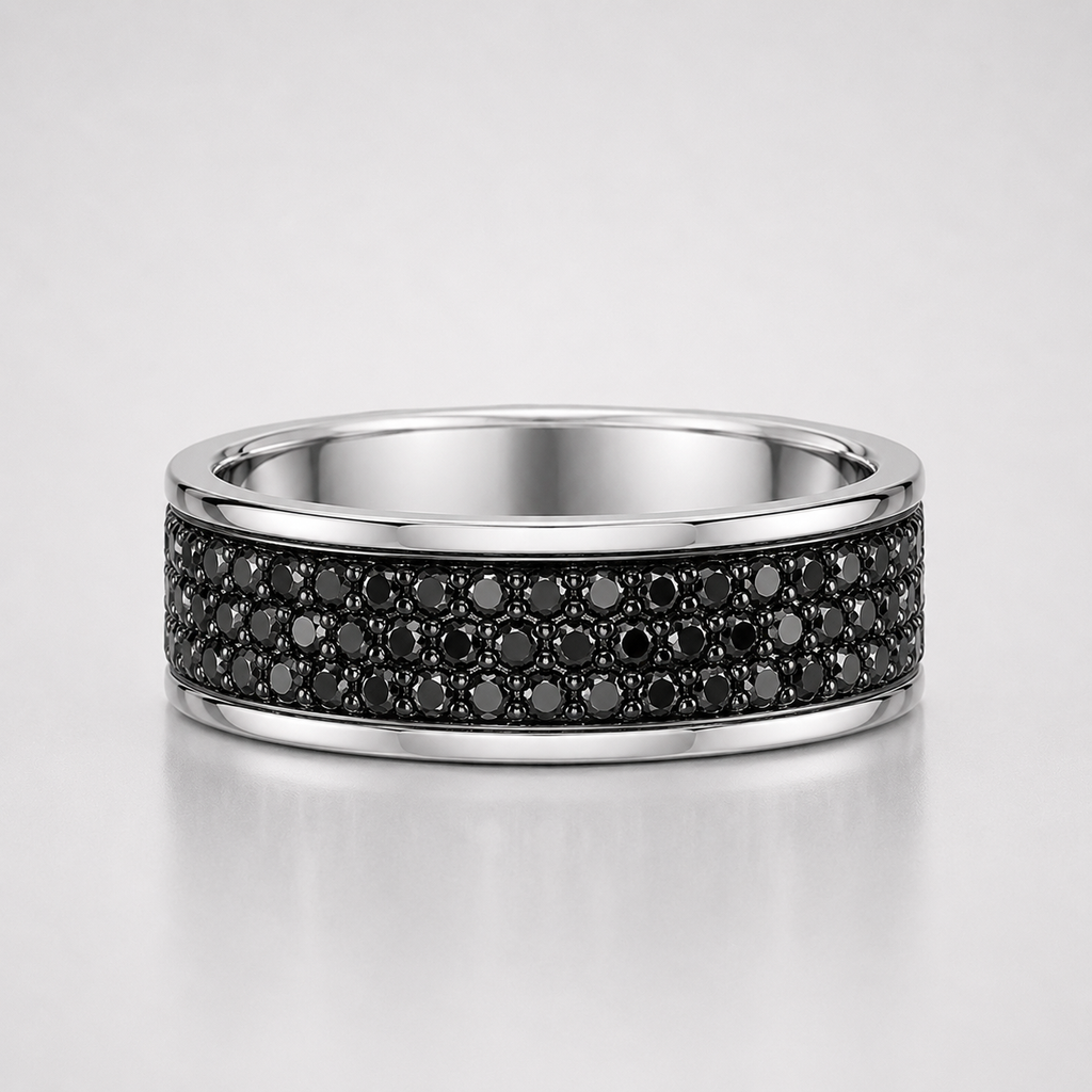 Silver ring with black gemstones on a light gray background