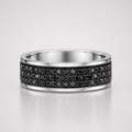 Silver ring with black gemstones on a light gray background