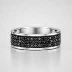 Silver ring with black gemstones on a light gray background
