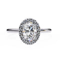 Diamond ring with a halo on a white background